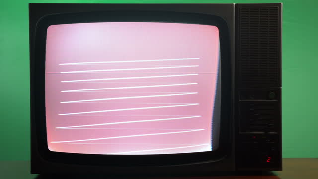 Old vintage blinking TV against green background, horizontal stripes and distortion on television screen, bad satellite signal on antique TV, broken television with noise and bars interference on monitor display