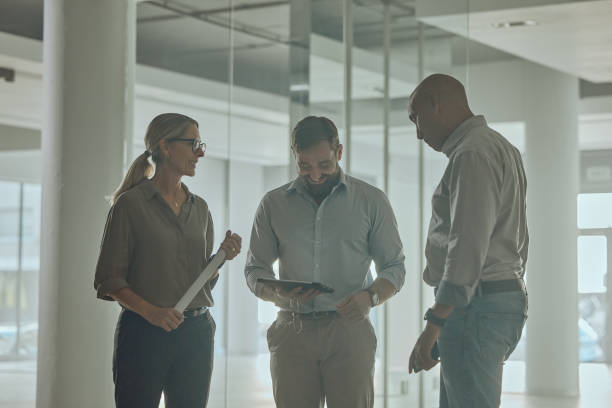 istock Business people, tablet and blueprint in construction planning, collaboration or digital design at office. Engineers in meeting for architecture, project floor plan or strategy on touchscreen at work 1472535857
