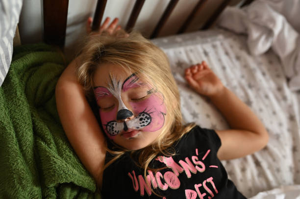 istock Little girl 3 years old with a painted face. 1472536020
