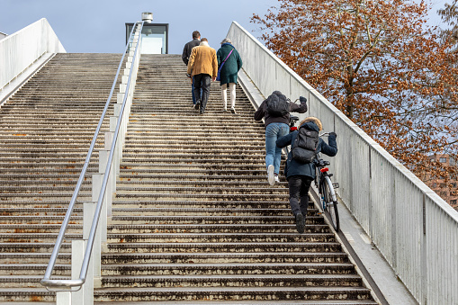 Cyclists who use a ramp specially designed to climb the stairs with their bikes, it's typically Dutch as a system and it's in Masstricht that it happens