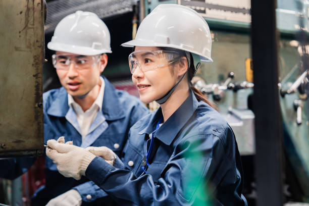 istock Technicians wearing protective goggles performing maintenance inspections on equipment 1472538407