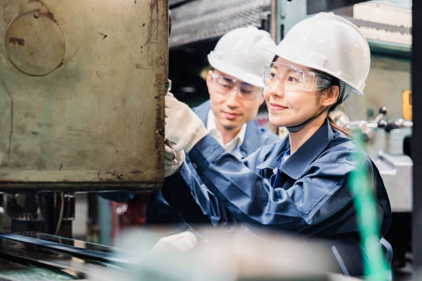 istock Technicians wearing protective goggles performing maintenance inspections on equipment 1472538416