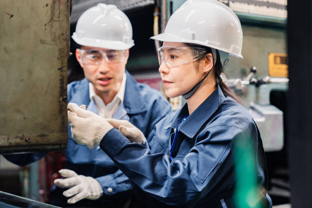 istock Technicians wearing protective goggles performing maintenance inspections on equipment 1472538420