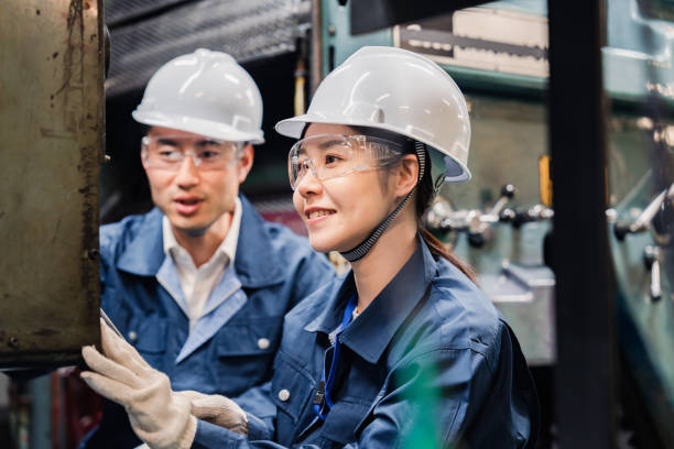 istock Technicians wearing protective goggles performing maintenance inspections on equipment 1472538432