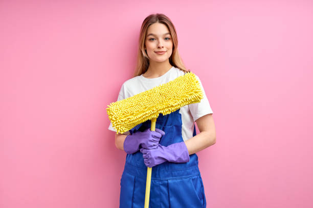 istock Nice young caucasian maid going to clean floor with mop 1472538855