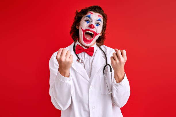 istock artistic Clown doctor with colourful make-up have fun 1472538989