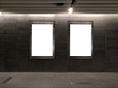 2 blank vertical advertising banners posters mockup in underground tunnel walkway; out-of-home OOH media display space, lightbox; 6 sheet template