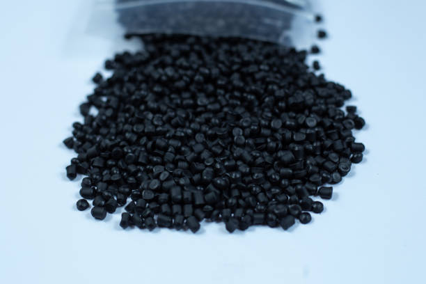 istock Close-up of black plastic polymer granules. polymer plastic. compound polymer. PVC resin compounds. Tinted plastic granulate for injection moulding process. 1472539848