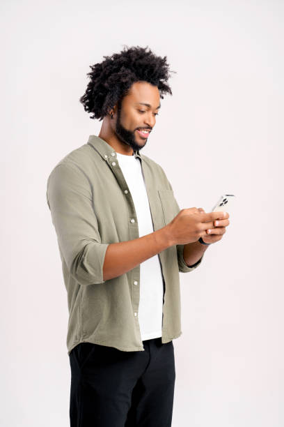 istock Funny surprised trendy guy read message on his mobile phone and expressing amazement, good news on smartphone. Studio shot 1472540056