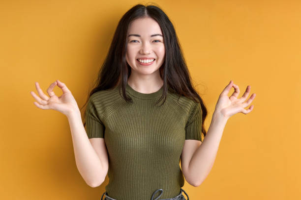 istock cheerful female concentrated on meditation, keep calm isolated in studio 1472540529