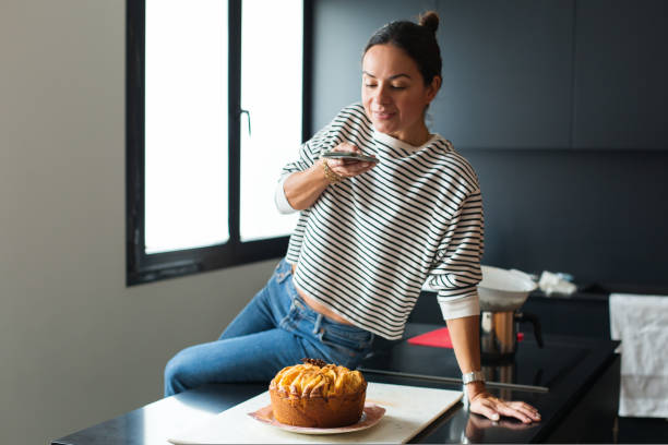 istock Woman making photo for a social media while cooking pie 1472541821