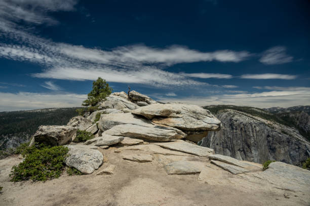 istock Rock Outcropping On Dewey Point Looks Down Into The Deep Valley Below In Yosemite 1472542102