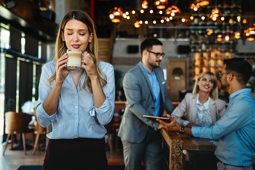 Happy business colleagues having conversation during coffee break