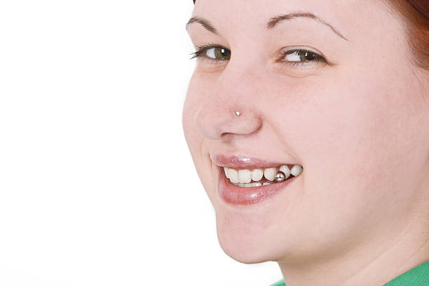 \\r\\nPortrait of a smiling pierced redheaded girl.