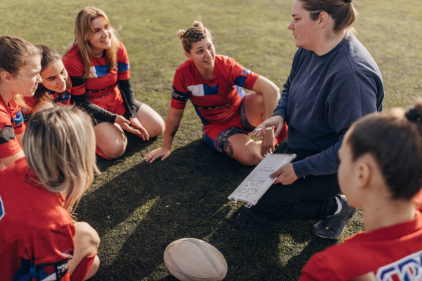 istock Female rugby team with coach 1472545896