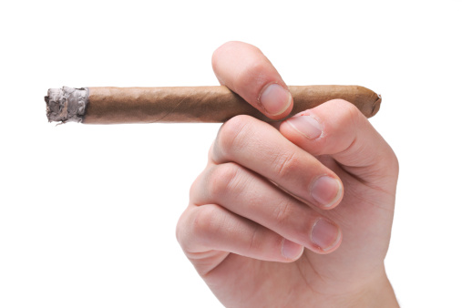 Person holding a cigar isolated on white
