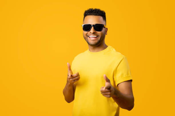 istock Portrait of young handsome Indian man pointing at camera 1472547573