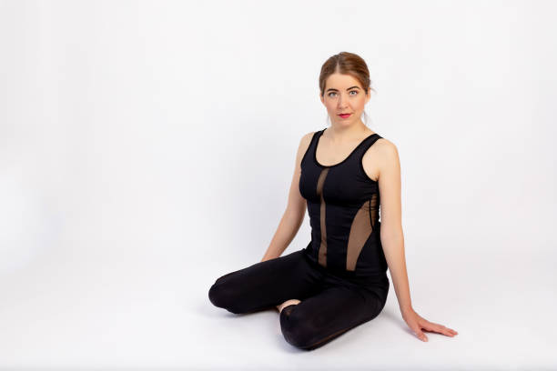 istock athletic girl sitting on a white background, space for text 1472548339