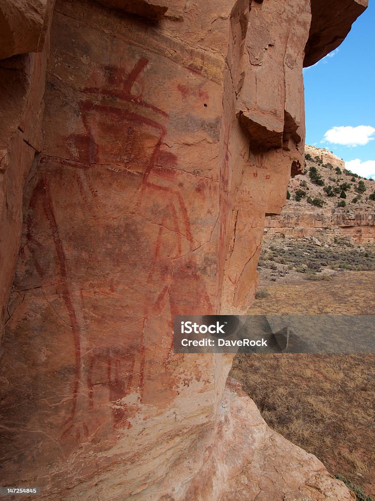 Pictographs of Snake Gulch Large anthropomorphic pictograph on cliff wall deep in Snake Gulch, Arizona. Paintings made by the ancient people of the Anasazi culture or prior. Here is a great depiction of what they might have looked like in regards to ornamental jewelry (note the ears) and headdress. American Culture Stock Photo