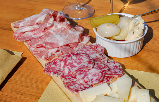 Typical Italian appetizer plate (cheese, salami, bacon, sour vegetables). Pleasurable hours with a winemaker. 