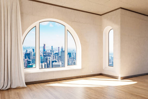 istock empty luxurious loft apartment with arched window and panoramic view over urban downtown; noble interior design mock up with white curtain and wooden floor; 3D Illustration 1472551164