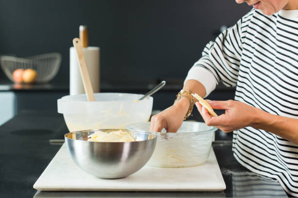istock Woman hands putting apples while cooking apple pie 1472554143