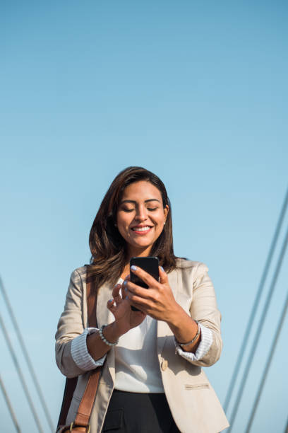 istock Teacher using her mobile phone outdoors 1472554357