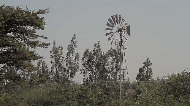 Old-fashioned windmill spinning on wind