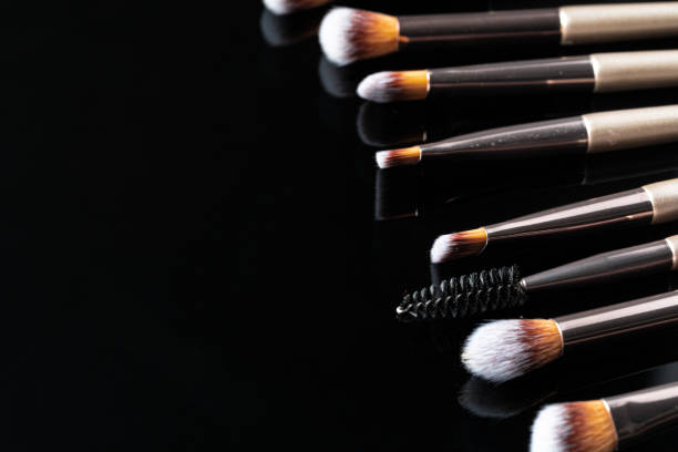 istock Collection of make up brushes on black background 1472554664