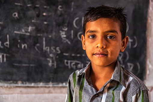 Indian schoolboy in classroom, English language class, Rajasthan, India