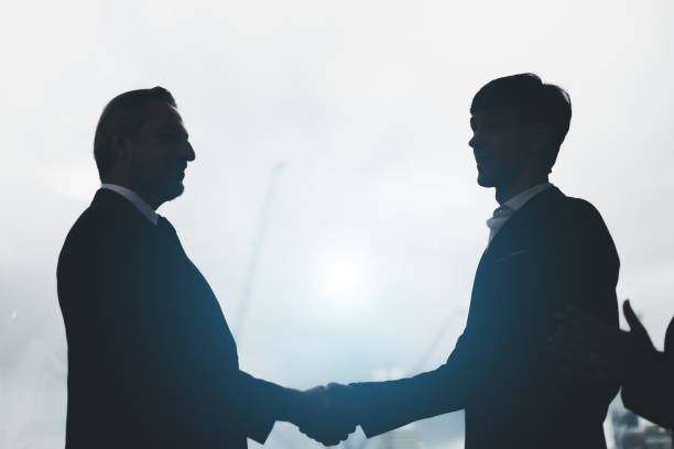 istock Smiling multiethnic businessmen shake hands greeting getting acquainted in office. Diverse multiracial male business partners handshake close deal make agreement after successful negotiation 1472555259