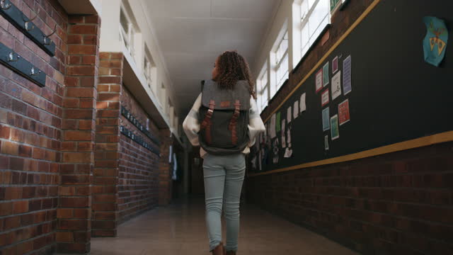 Education, backpack and student walking in school to class in hallway or corridor. Development, learning scholarship and kid or girl walk in kindergarten alone for studying and academic knowledge.