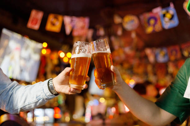 istock People drinking beer on pub and bar background. St. Patrick's Day 1472555917