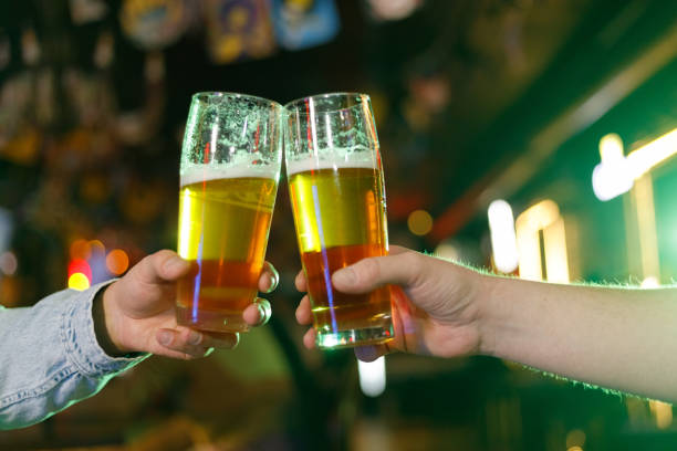 istock People drinking green beer on pub and bar background. St. Patrick's Day 1472555958