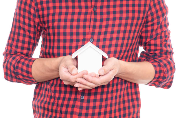 Man holding small house model isolated on white background with clipping path