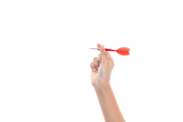 istock Female hand holding a darts isolated on white background with clipping path. 1472557355
