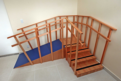 Hall way to private house and staircase to second floor. Illuminated wooden staircase.