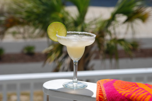 Margarita with lime slice and beach towel.