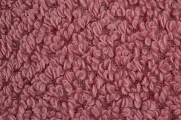 istock multicolored terry towels, rolled up and stacked on the table 1472562418