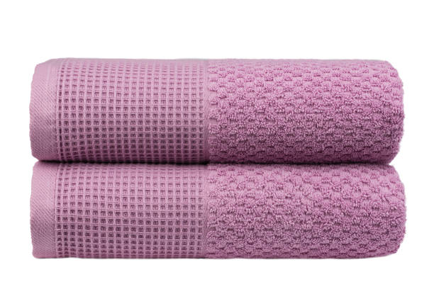 istock multicolored terry towels, rolled up and stacked on the table 1472562621