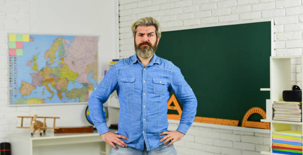 School subject. Basic education. History and geography. Science concept. Mature bearded teacher in classroom. Private lesson. Back to school. Study with interest. Man mentoring school projects.