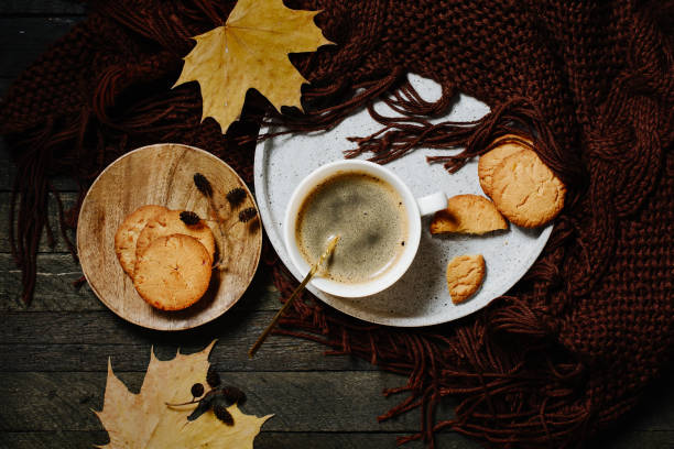 istock Cup of coffee with orange cookies. 1472567892