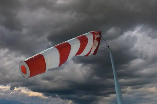 Photo of Attention storm warning! Windsock in front of an approaching thunderstorm front.