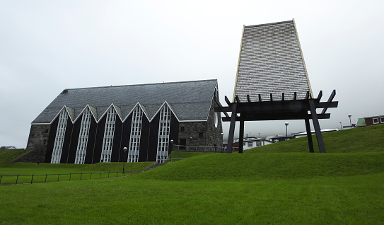 Fisheye lowangle defocused shot of Sandavágs kirkja (church) on a cloudy rainy day in Sandavágur, Faroe Islands.