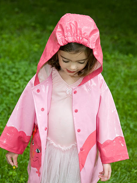 Little Girl Standing in the Rain stock photo