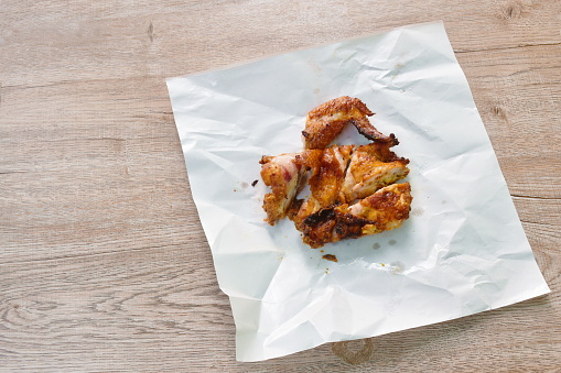grilled chop chicken wing on white paper packaging take out food