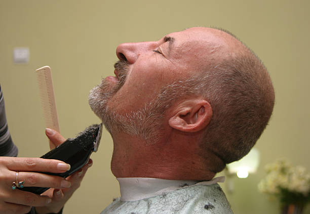Man is getting a shave at the barber shop