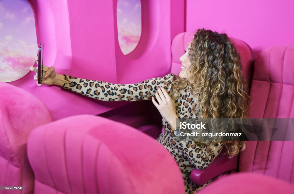 Young woman sitting in the window seat of a commercial airliner Airplane Stock Photo