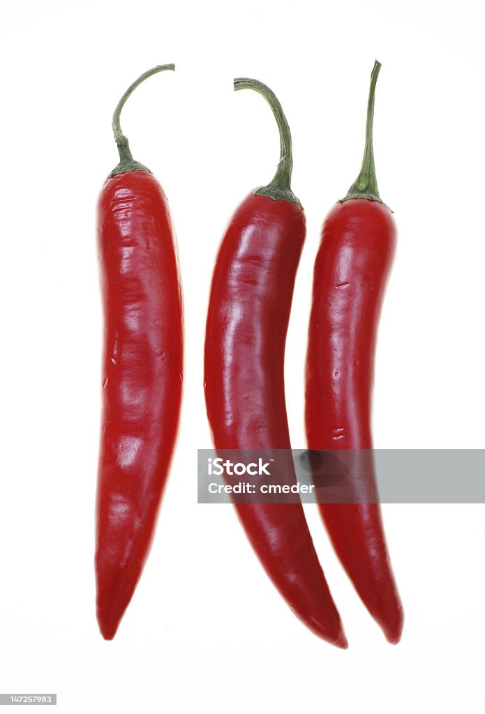 Tre rosso chillies - Foto stock royalty-free di Bianco