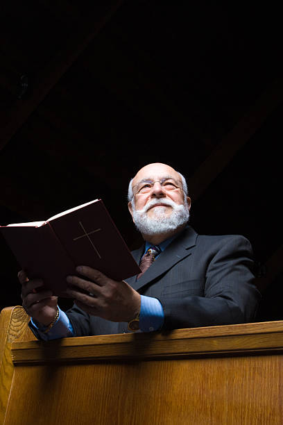 istock Older White Man Hold Hymnal in Church Pew 147257985